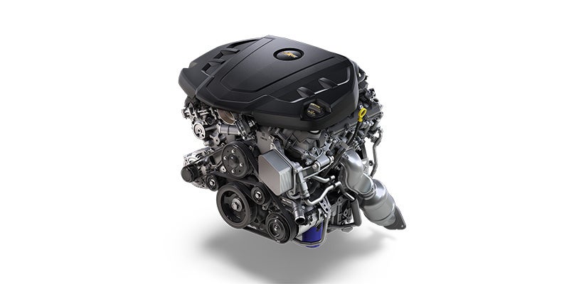 Detailed view of a modern turbocharged engine with black cover and exposed mechanical components, isolated on white background.