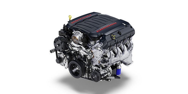 Detailed image of a V8 supercharged engine, highlighting its high-performance components.
